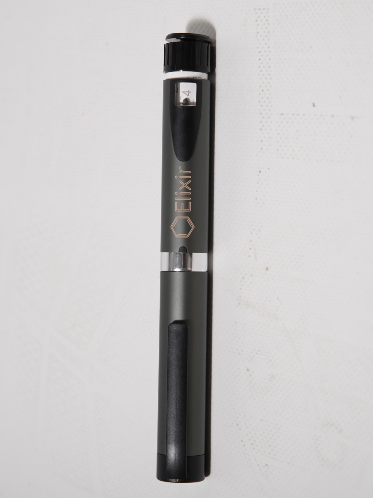 The Elixir Pen — matte finish with the gold hexagon mark
